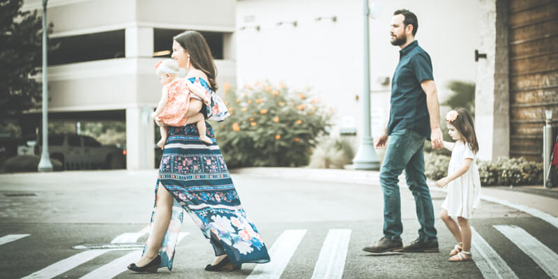 Family crossing the road