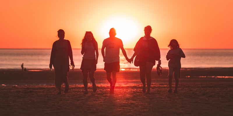 Family holding hands at sunset symbolising wills.