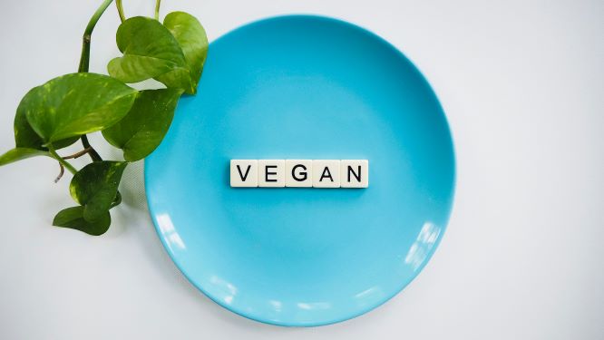 Plate with scrabble letters spelling VEGAN.