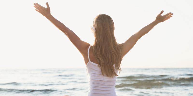 Woman stretching arms with peace of mind