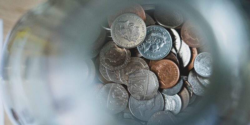 British currency in coins reflecting furlough and UK budget