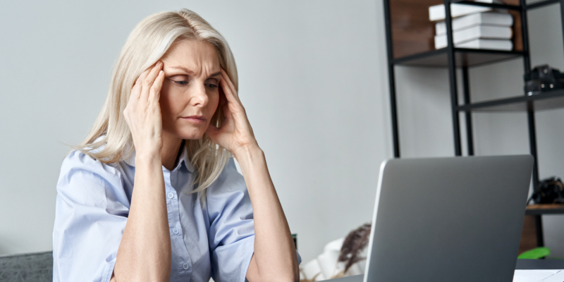 Menopausal aged woman at a laptop