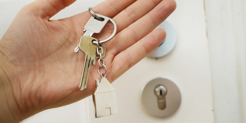 Hand with house keys signifying property ownership and property fraud