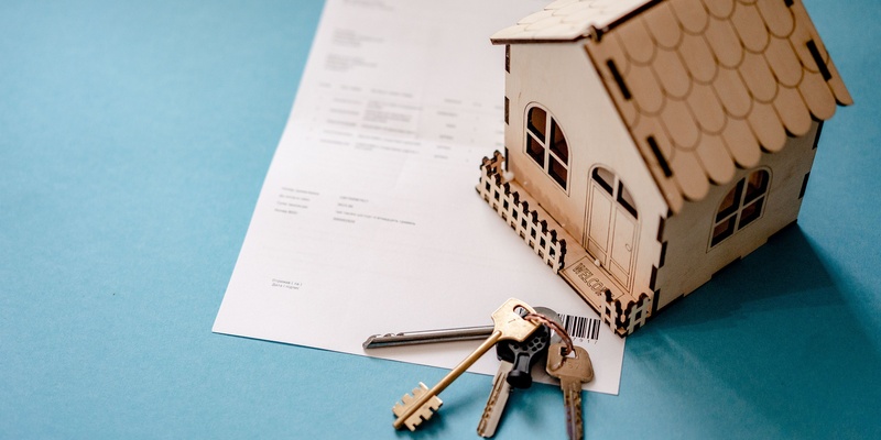 Contract invoice, wooden house and house keys signifying renting no-fault evictions