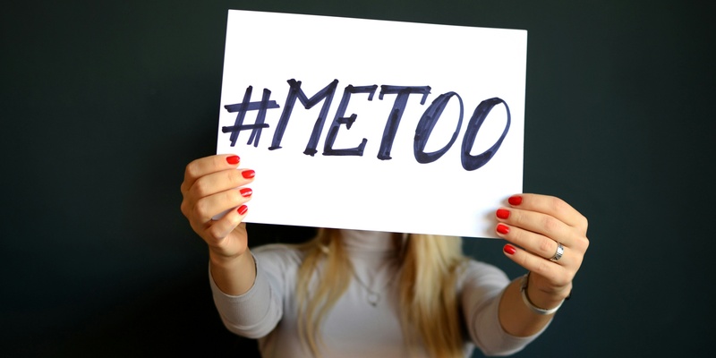 #MeToo placard beign held by a woman signifying sexual assault in the workplace