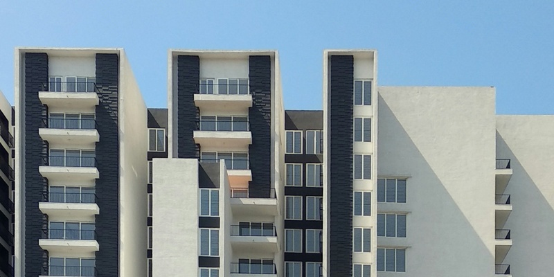 Black and white apartment block against blue sky signifiying the Renters Reform Bill and no fault eviction.